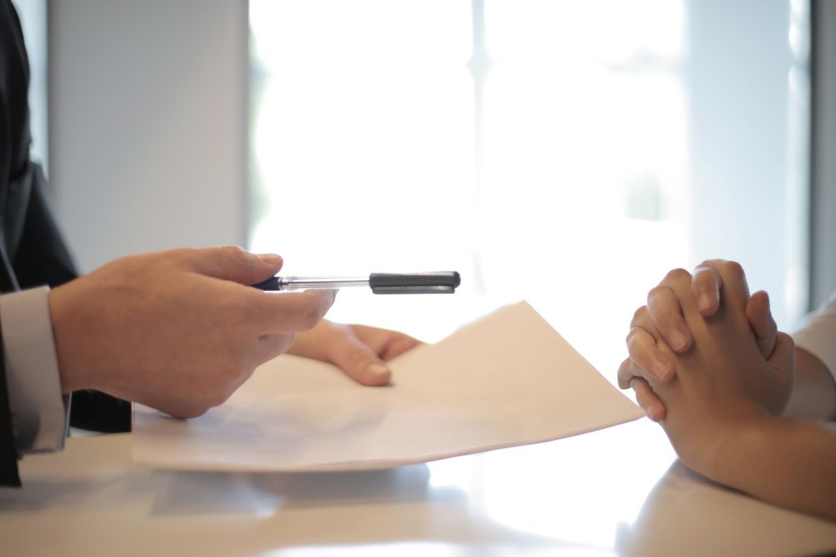 Documents passed across a table between two people